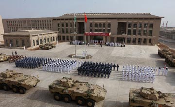 Beijing has been flexing its military muscle, opening its first overseas military base in Djibouti and building militarised artificial islands in the disputed South China Sea .