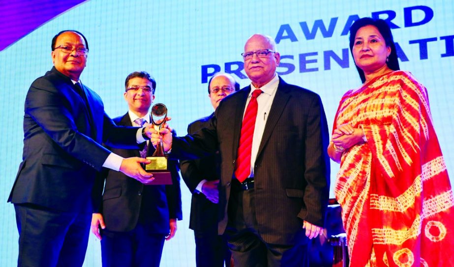 Finance Minister Abul Maal Abdul Muhith, handing over the SAFA BPA Reports Award-2016 to M. Kamal Hossain, Managing Director of Southeast Bank Limited for best corporate governance among private sector banks by Institute of Chartered Accountants of Bangla