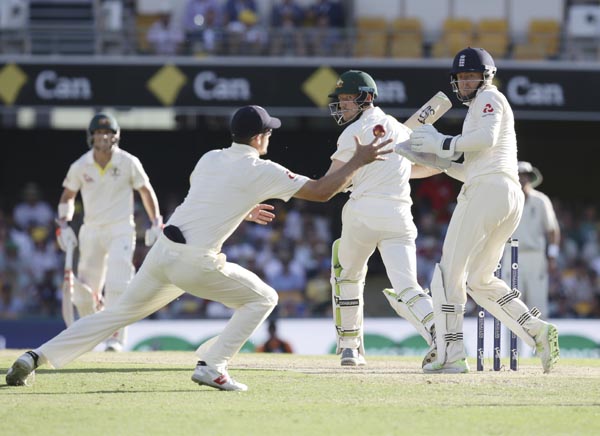 Australia's Cameron Bancroft, center, looks back as England's Alastair Cook, left, tries to take a catch during the Ashes cricket Test in Brisbane, Australia on Sunday.
