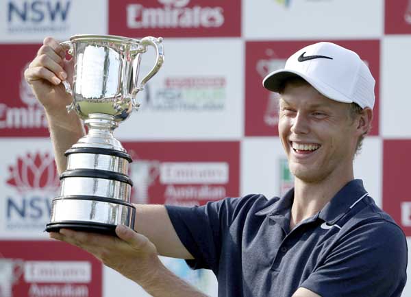 Australia's Cameron Davis smiles after being presented his trophy after winning the Australian Open Golf tournament in Sydney on Sunday.