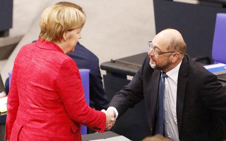 Angela Merkel speaks with Martin Schulz, the leader of the Social Democrats Party