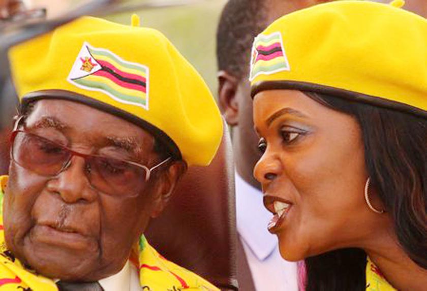 President Robert Mugabe listens to his wife Grace Mugabe at a rally of his ruling ZANU(PF) party in Harare, Zimbabwe.