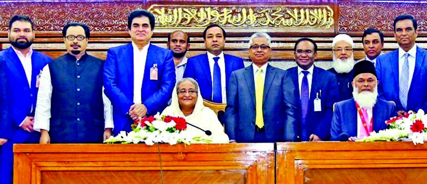 Prime Minister Sheikh Hasina poses for a photo session after receiving donation to support the cold-hit people of the country from Prime Bank Limited at PMO on Monday. Azam J Chowdhury Chairman of the bank and Nazrul Islam Mazumder President of Bangladesh