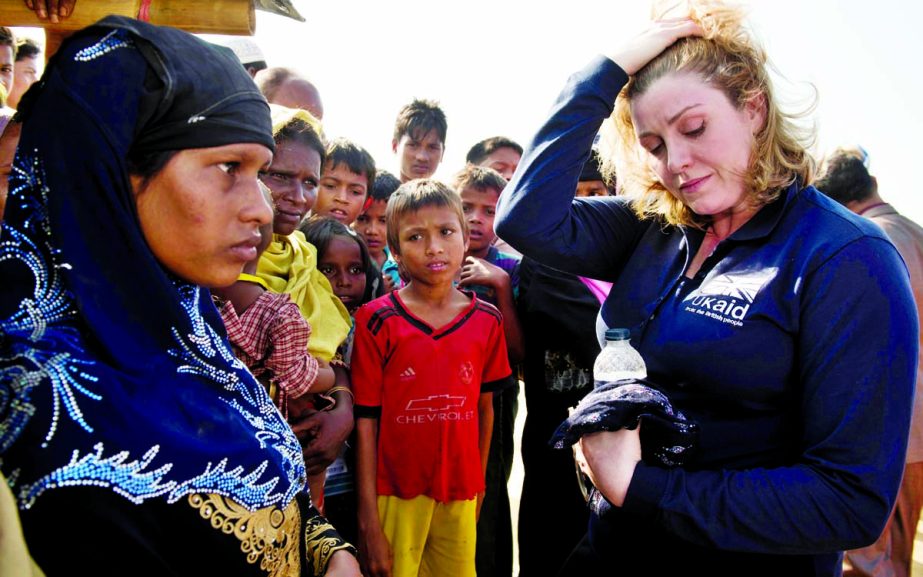 Secretary of State for International Development, Penny Mordaunt, listens to Yasmin 15 in Kutupalong refugee camp in Bangladesh.