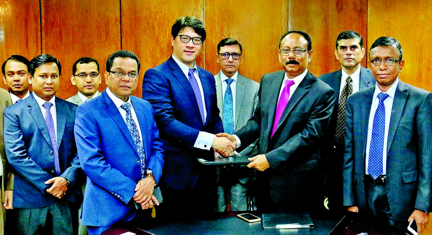 Md. Quamrul Islam Chowdhury, Additional Managing Director of Mercantile Bank Limited and Ka-Kit Man, CEO of Capital and Credit Risk Manager of (CCRM), exchanging an agreement signing documents at the bank's head office in the city recently. Under the de