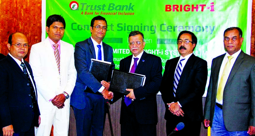 Ishtiaque Ahmed Chowdhury, Managing Director of Trust Bank Limited and Palash Roy, Managing Director of Bright IT, exchanging an agreement signing documents at Swadhinata Tower in the city on Sunday. Under the deal, Bright IT will maintain the data center