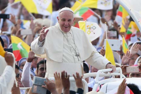 Pope Francis waves as he arrives to lead a mass at Kyite Ka San Football Stadium in Yangon, Myanmar on Wednesday.