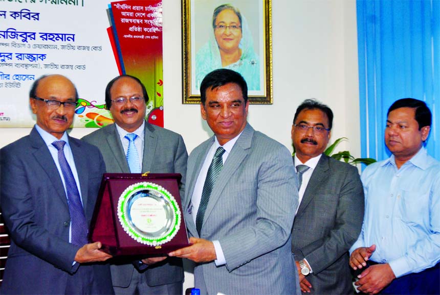 Md. Abdul Halim Chowdhury, Managing Director of Pubali Bank Limited, receiving an award from Fazle Kabir, Governor of Bangladesh Bank as the highest tax-payer in the banking and non-banking financial institution category recently. Md. Nojibur Rahman, Chai