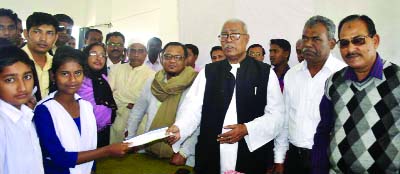 RAMPAL (Bagerhat): Director of South Bangla Agriculture and Commerce Bank (SBAC) Talukder Abdul Khalek MP distributing stipend among the poor students at Rampal Upazila organised by the Bank on Monday.