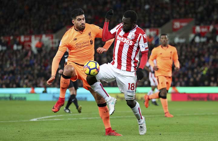 Stoke City's Mame Diouf (right) is challenged by Liverpool's Emre Can during their English Premier League soccer match at the bet365 Stadium in Stoke, England on Wednesday.