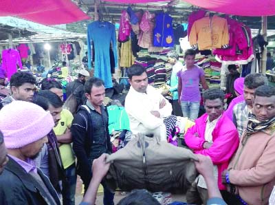 DINAJPUR (South): Selling of winter clothes going on in Fulbari footpath.