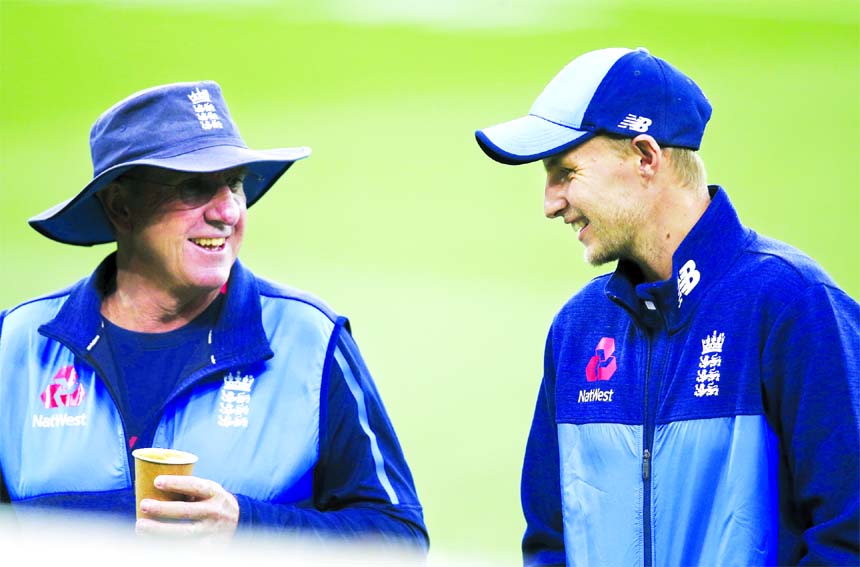 England's cricket captain Joe Root (right) and head coach Trevor Bayliss smile as they walk off the ground as the England team arrives to train for their next Ashes test match in Adelaide on Friday. Australia will play England in the second cricket Test