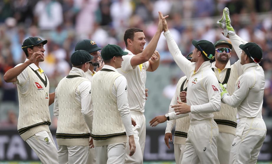 Australia's Josh Hazlewood, center, celebrates with teammates after taking the wicket of England's James Vince for 2 runs during the third day of their Ashes cricket Test match in Adelaide, Monday