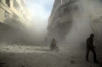 People are seen during shelling in the town of Hamoria, eastern Ghouta in Damascus, Syria,