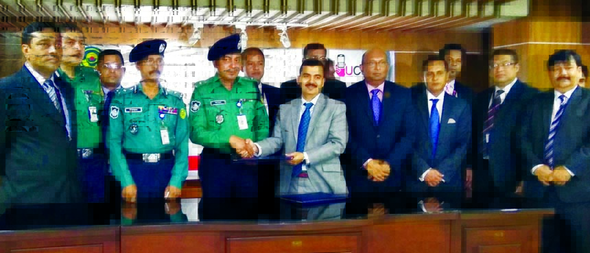 A E Abdul Muhaimen, Managing Director of United Commercial Bank Limited and Md. Iqbal Bahar, Police Commissioner of Chittagong Metropolitan Police (CMP), exchanging an agreement signing documents on "E-trafficking Prosecution and Fine Payment System" at