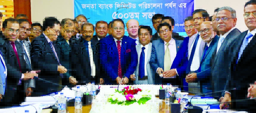 Shaikh Md. Wahid-uz-Zaman, Chairman of Board of Directors of Janata Bank Limited, inaugurating its 500th Board Meeting by cutting cake at the bank's head office in the city on Monday. Md. Abdus Salam Azad, Managing Director, Manik Chandra Dey, Masih Mali
