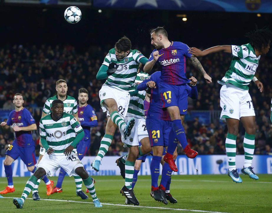Barcelona's Paco Alcacer (center) heads the opening goal during the Champions League Group D soccer match between FC Barcelona and Sporting CP at the Camp Nou stadium in Barcelona, Spain on Tuesday.