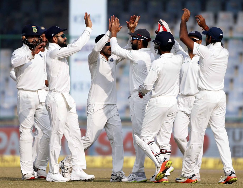 India'n players celebrate the dismissal of Sri Lanka's Angelo Mathews during the fifth day of their third test cricket match in New Delhi, India on Wednesday.