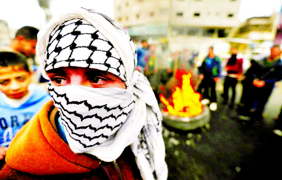 A masked Palestinian takes part in a protest against U.S. President Donald Trump's decision to recognize Jerusalem as the capital of Israel, in Khan Younis in the southern Gaza Strip on Thursday. Internet photo