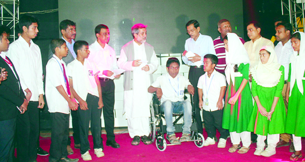 Chairman of the Parliamentary Standing Committee on Ministry of Railway ABM Fazle Karim Chowdhury MP seen among the physically disabled students who distributed wheel chairs and cash donations to them as Chief Guest on Wednesday.