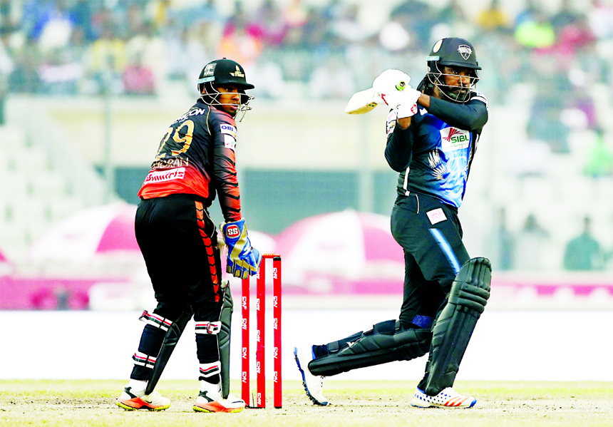Chris Gayle of Rangpur Riders misses a shot while wicketkeeper Nicholas Pooran of Khulna Titans tries to stump out him during the match of the Eliminator of the AKS Bangladesh Premier League (BPL) Twenty20 Cricket between Rangpur Riders and Khulna Titans