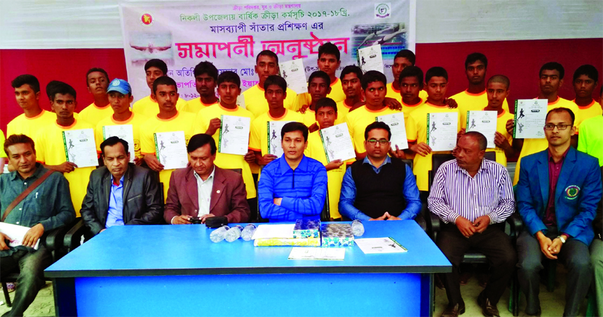 The talent swimmers of Nikli Upazilla with certificates and with the Additional DC of Kishoreganj Tarafder Md Akter Jamil pose for photograph at Nikli Upzila in Kishoreganj on Friday.