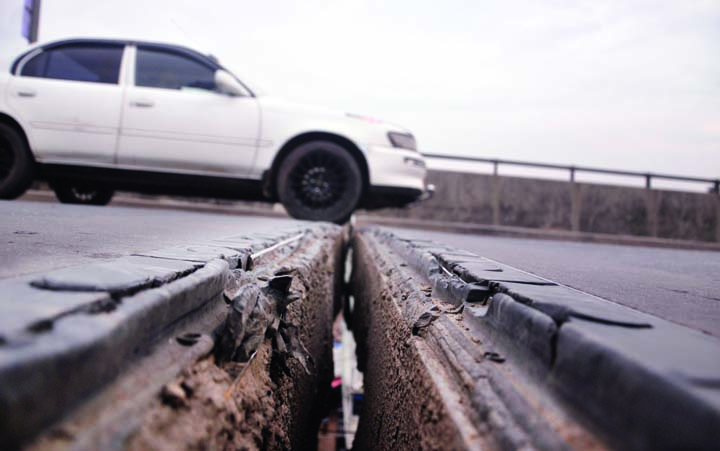 A large potholes and cracks were developed in the middle of the Sultana Kamal Bridge on Dhaka-Sylhet Highway resulting major accident may occur any time. But the authorities concerned turned a blind eye to repair the problem. This photo was taken from Rup