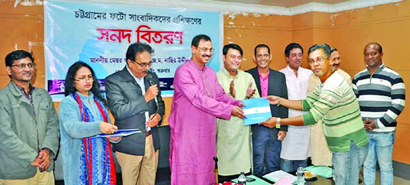 CCC Mayor AJM Nasir Uddin seen handing over training certificates among the photojournalists on the concluding session of the 3 -day long training programme yesterday.
