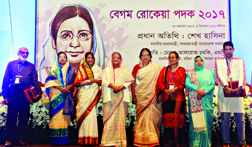 Prime Minister Sheikh Hasina poses for photo session with the recipients of Begum Rokeya Padok, 2017 at Osmani Memorial Auditorium on Saturday.