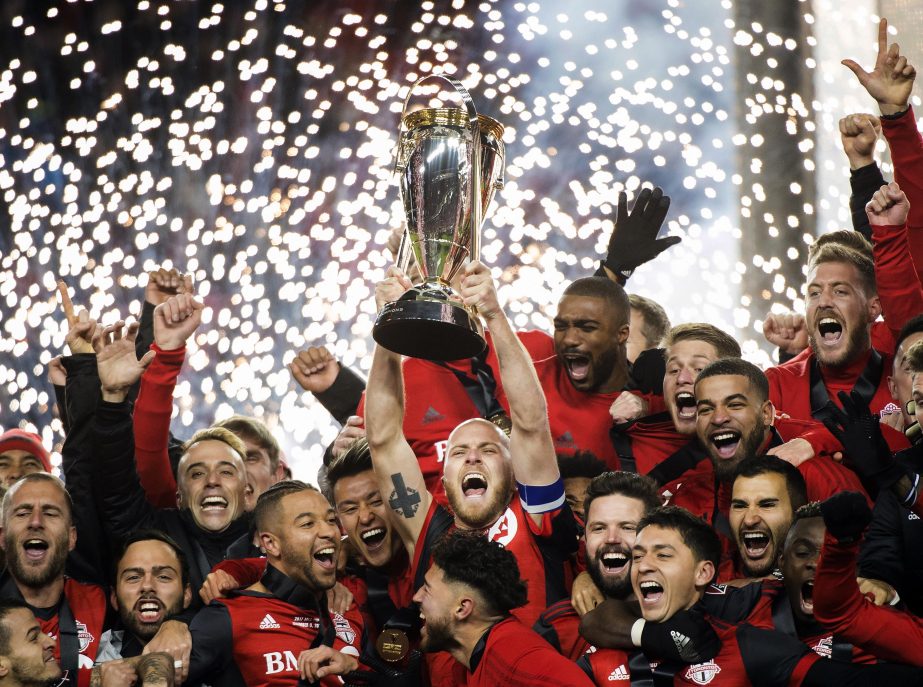 Toronto FC captain Michael Bradley hoists the trophy as the team celebrates its win over the Seattle Sounders in the MLS Cup final in Toronto on Saturday.