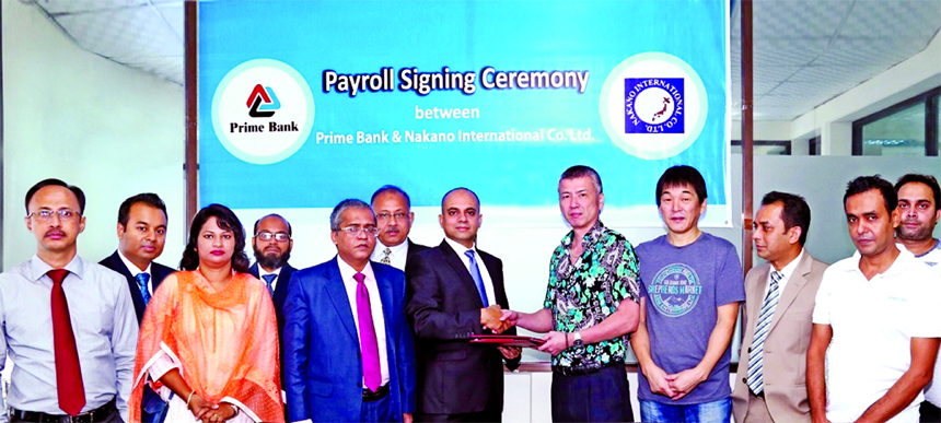 Mamur Ahmed, Head of Sales and Collection of Consumer Banking Division of Prime Bank Limited and Masahiko Ono, General Manager (Administration) of Nakano International Company Limited, exchanging the "Prime Payroll" agreement signing documents at the ba