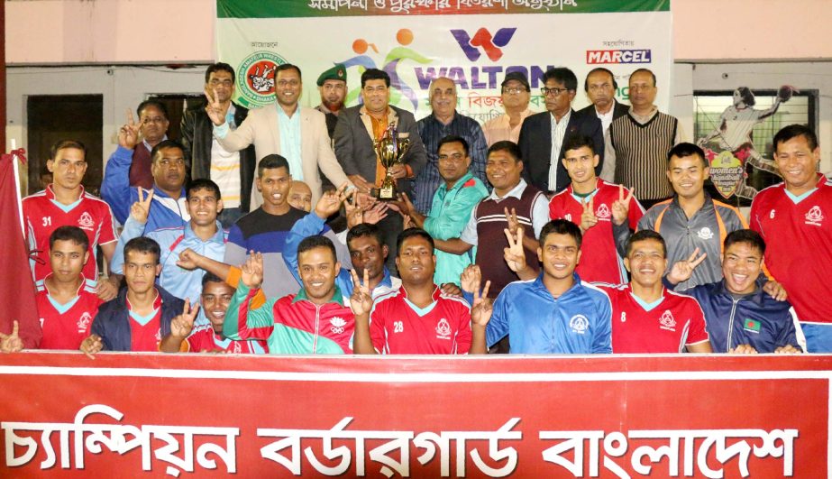 Members of Border Guard Bangladesh, the champions of the Men's Group of the Walton Victory Day Wrestling Competition with the guests and officials of Bangladesh Amateur Wrestling Federation pose for a photo session at the Shaheed (Captain) M Mansur Ali N