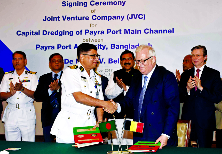 Commodore Jahangir Alam, Chairman of Payra Port Authority and Jan Piter De Nul, Managing Director of Jan De Nul's, (a Belgium-based company) shaking hands after signing an agreement to jointly conduct capital dredging on the main channel of the country'