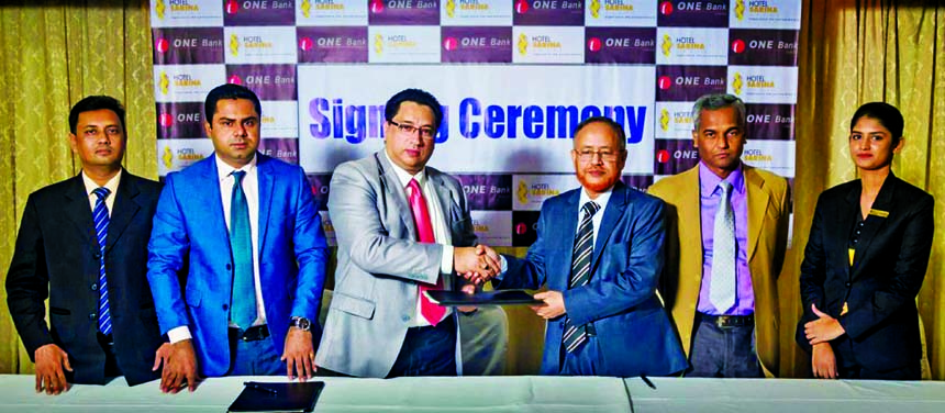 Syed Maruf Ali, Head of Card Division of ONE Bank Limited and Mohammad Ali Chowdhury, Director (Finance) of Hotel Sarina Dhaka, exchanging a MoU signing documents at the banks head office in the city recently. Under the deal, all cardholders and employees