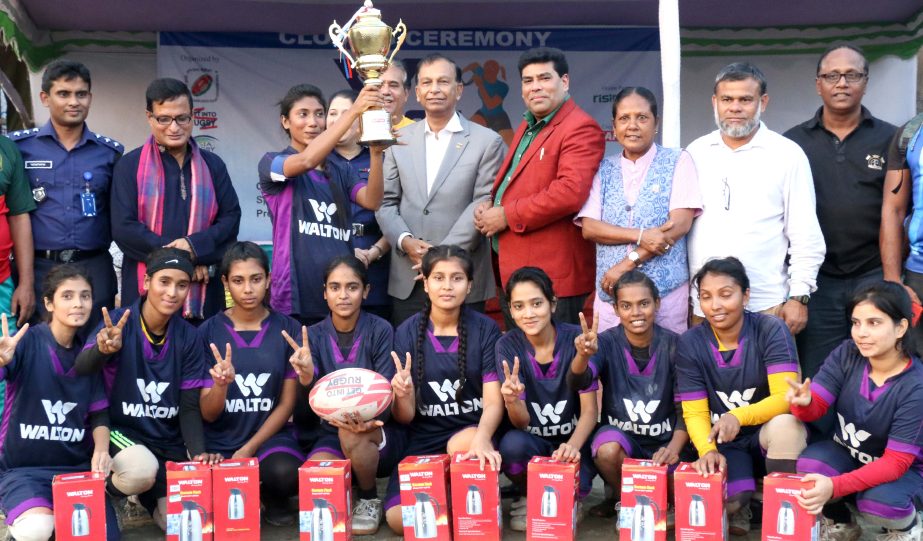 Members of Narail District team, the champions of the 2nd Walton National Women's Competition with the guests and officials of Bangladesh Rugby Union pose for a photo session at the Paltan Maidan on Tuesday.