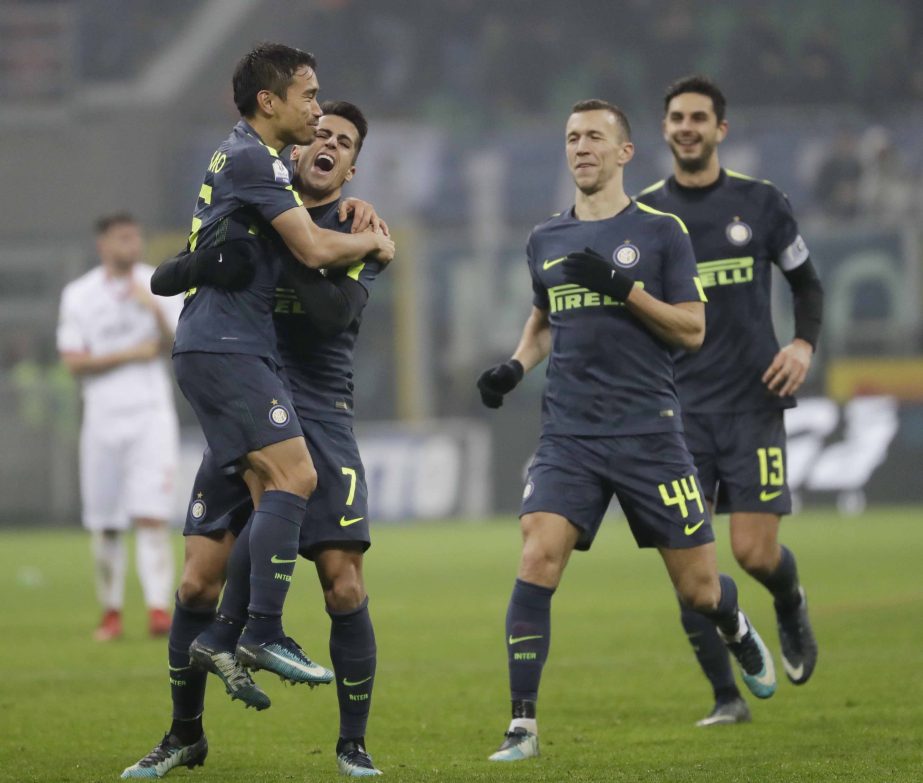 Inter Milan's Yuto Nagatomo (left) celebrates with teammates Joao Cancelo, Ivan Perisic and Andrea Ranocchia after scoring the decisive penalty during the Italian Cup soccer match between Inter Milan and Pordenone at the San Siro stadium in Milan, Italy