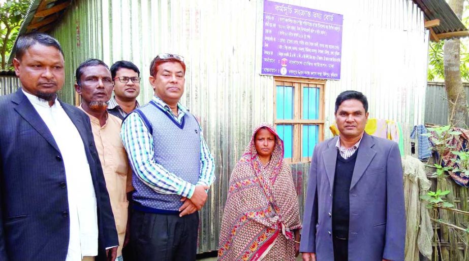KURIGRAM: Hiader Ali Mia, Chairman, Ulipur Upazila Parishad distributing tin-shed houses among the poor people at the Upazial organised by Tobakpur Samaj Klayan Sangstha recently.