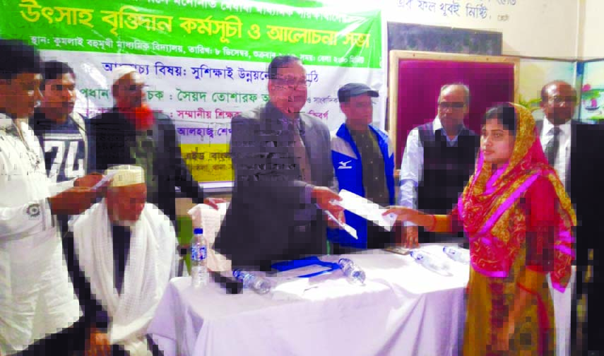 Veteran journalist and columnist Syed Tosharaf Ali handing over stipend among the meritorious students of Kumlai Multilateral Secondary School in Bagerhat recently. Retired District Judge Sheikh Jalal Uddin was present, among others, on the occasion.