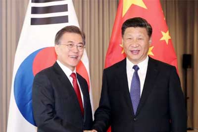 South Korean President Moon Jae-In, shaking hands with Chinese President Xi Jinping at the Great Hall of the People in Beijing on Thursday.