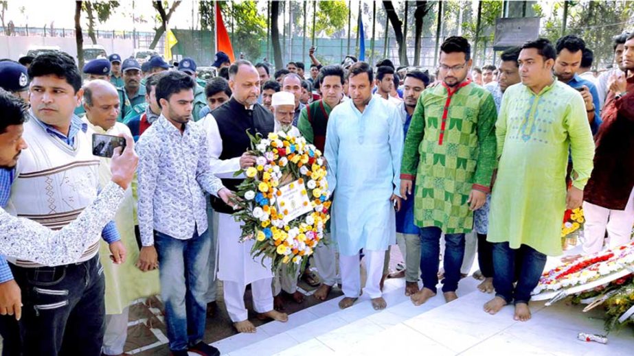 M A Latif MP placing wreaths at Bondar Republic Club Memorial in observance of the Victory Day on Saturday.