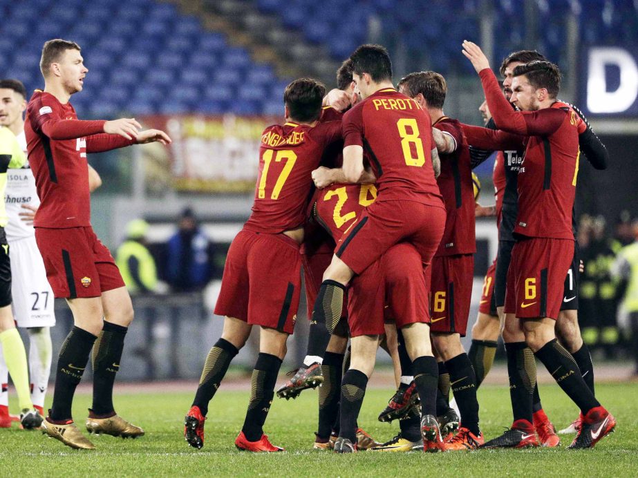 Roma's Federico Fazio (hidden) celebrates with teammates after scoring the decisive goal during an Italian Serie A soccer match between AS Roma and Cagliari, at the Olympic stadium in Rome on Saturday.