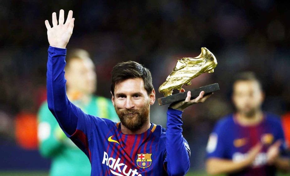 FC Barcelona's Lionel Messi holds up the Golden Shoe award, as the last season's leading goalscorer in league matches from the top division of every European national league, prior of the Spanish La Liga soccer match between FC Barcelona and Deportivo C
