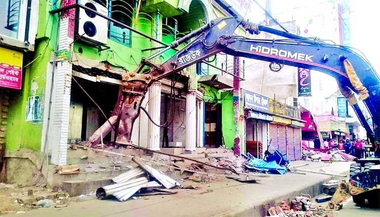 RAJUK authority demolishing the illegally constructed structures in city's Mirpur Section-10 on Monday.