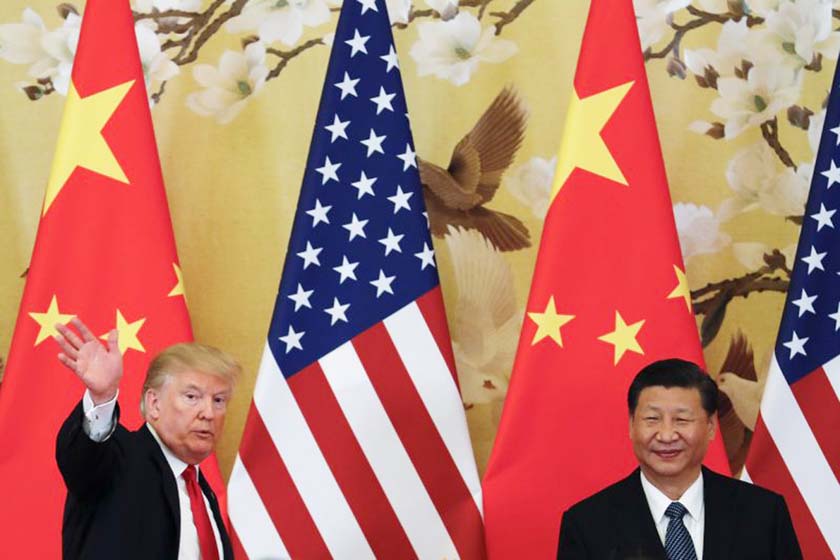 US President Donald Trump waves next to Chinese President Xi Jinping after attending a joint press conference at the Great Hall of the People in Beijing.