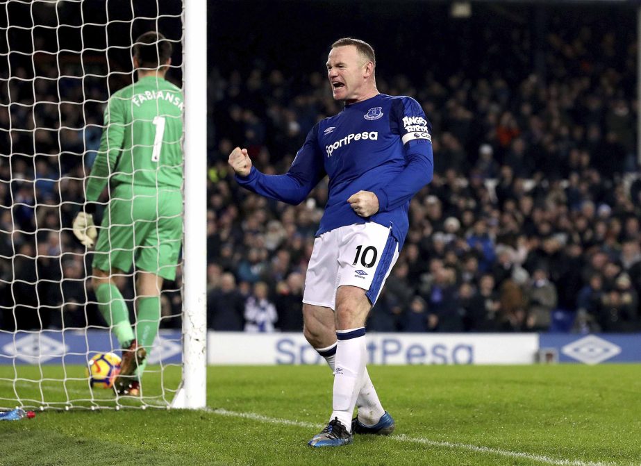 Everton's Wayne Rooney celebrates scoring his side's third goal of the game from the penalty spot during their English Premier League soccer match Everton versus Swansea City at Goodison Park in Liverpool, England on Monday.