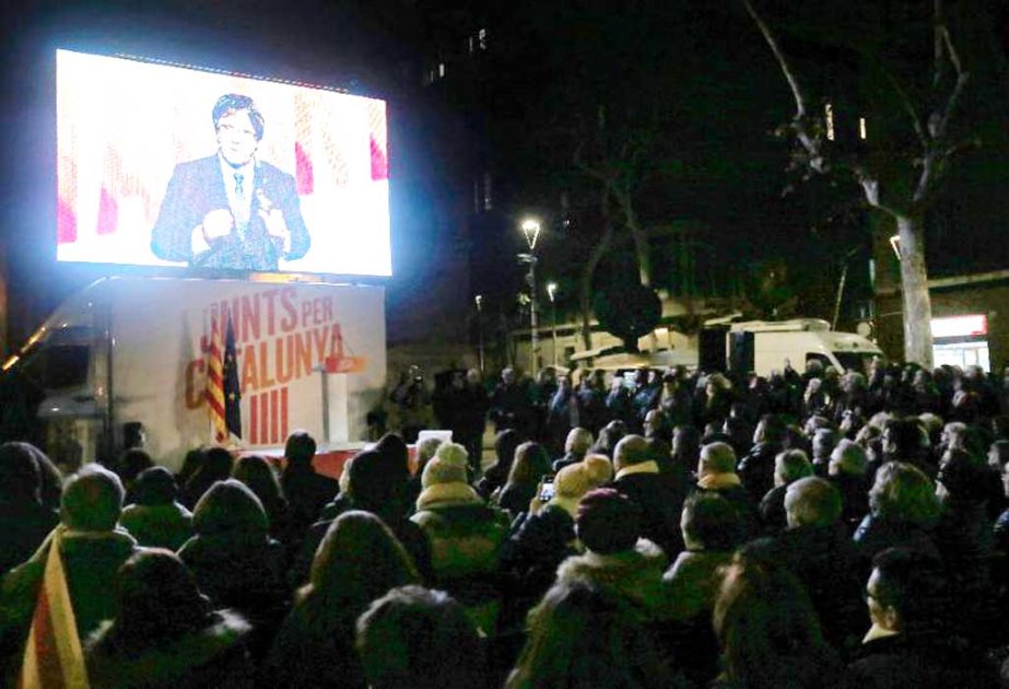 Deposed Catalan Leader Carles Puigdemont speaks via video-conference from Brussels during the final campaign meeting for the upcoming Catalan regional election on Tuesday.