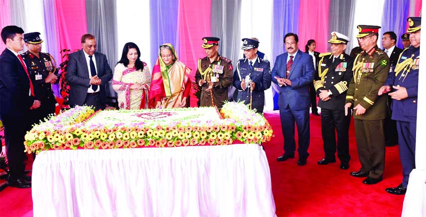 Prime Minister Sheikh Hasina cutting cake at the tea party after addressing parade of the border force marking the Border Guard Bangladesh Day-2017 at its Pilkhana Headquarters in the city yesterday.