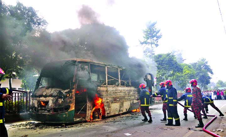 Fire fighters trying to douse the flame when a passenger bus catches fire due to technical malfunction and cylinder blast of unfit vehicle. This photo was taken from in front of Bangabandhu Sheikh Mujib Medical University at Shahbagh intersection in city