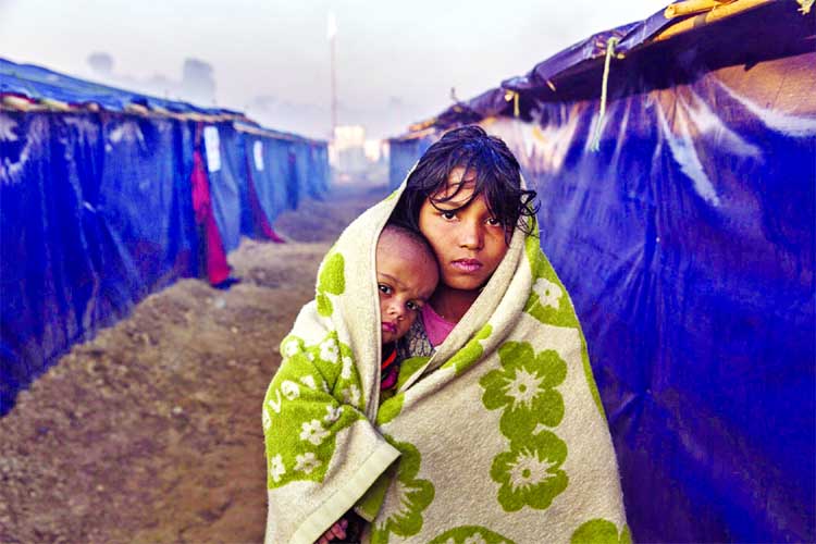 A young Rohingya refugee and her 10-month-old niece for a walk in the early morning at Kutupalong camp in Cox's Bazar to warm up from the cold inside their shelter.