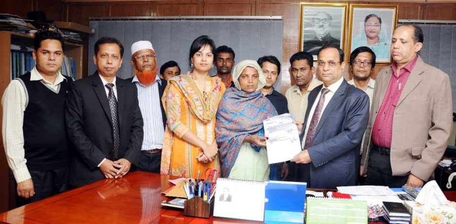 Prof Dr Gowtom Buddho Das, VC, Chittagong Veterinary and Animal Science University giving a temporary appointment letter to Chandona Das, wife of late Krisna Pada Das at Bangomata Fazilatunnessa Hall as office Assistant who died by fatal stampede